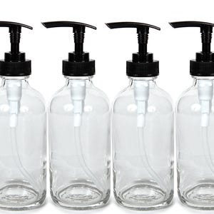 May include: Four clear glass bottles with black pump tops. The bottles are empty and ready to be filled with your favorite liquids.