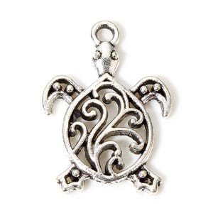May include: Silver-coloured metal turtle charm with an openwork design. The charm features a detailed turtle shape with a loop for attaching to jewellery. The turtle's shell has a decorative, swirling pattern.