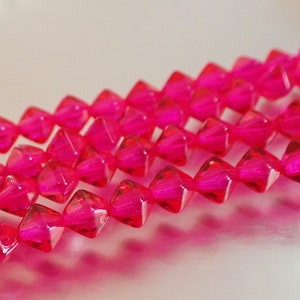 25 - Cuentas bicono lisas de 6 mm, color rosa fucsia, de cristal checo