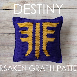 May include: Crocheted cushion with a purple background and a yellow Destiny Forsaken logo. The cushion is on a wooden surface.