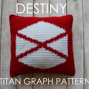 May include: Red and white crocheted cushion with a Destiny Titan symbol. The cushion has the text "TITAN GRAPH PATTERN" below it.