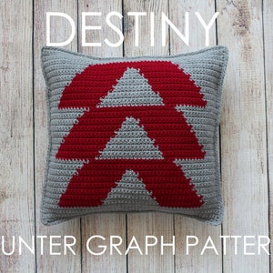 May include: Crochet pattern for a Destiny Hunter emblem cushion. The cushion is grey with a red triangle design. The text "HUNTER GRAPH PATTERN" is below the cushion.