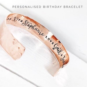 May include: A copper bracelet with the inscription "30th Stephanie Love Gail & Jan" engraved on it.