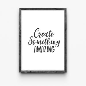 May include: A black and white framed print with the text "Create something amazing" in a handwritten font.