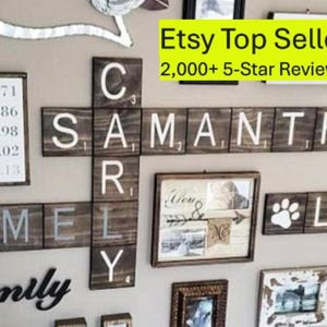 May include: A wall display featuring dark brown wooden tiles arranged like a crossword puzzle with white letters and numbers. The tiles spell out names including Rich, Hamel, Cary, Samantha, Jarod, and Loki. Includes framed photos and text.