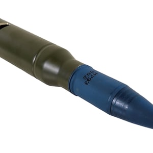 May include: A green and blue military projectile with the text "H762 200" printed on the side.