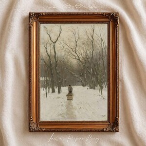 May include: A framed oil painting depicting a solitary figure pulling a small cart through a snow-covered forest path lined with tall, bare trees. The artwork is encased in an ornate, metallic bronze-coloured frame with intricate carvings.