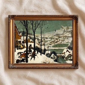 May include: A framed landscape painting depicting a winter scene with snow-covered houses, bare trees, and a group of hunters with dogs in the foreground. The background features a frozen river with figures skating and distant mountains under a grey sky.