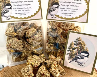 May include: Two clear plastic bags filled with Mini Bird Bites, a blend of seeds, nuts, fruit, grains, suet, and gelatin. Each bag has a label featuring a chickadee illustration and text. A matching card with a chickadee image is included.