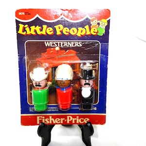 May include: Vintage Fisher-Price Little People Westerners set. The package features three figures: a cowboy, a construction worker, and a man in a tuxedo. The packaging is a blue, red, and brown color scheme with the words "Little People" and "Westerners" printed on it.
