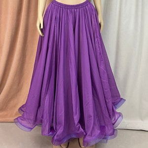May include: A long, flowing purple skirt with a gathered waist and a ruffled hem.