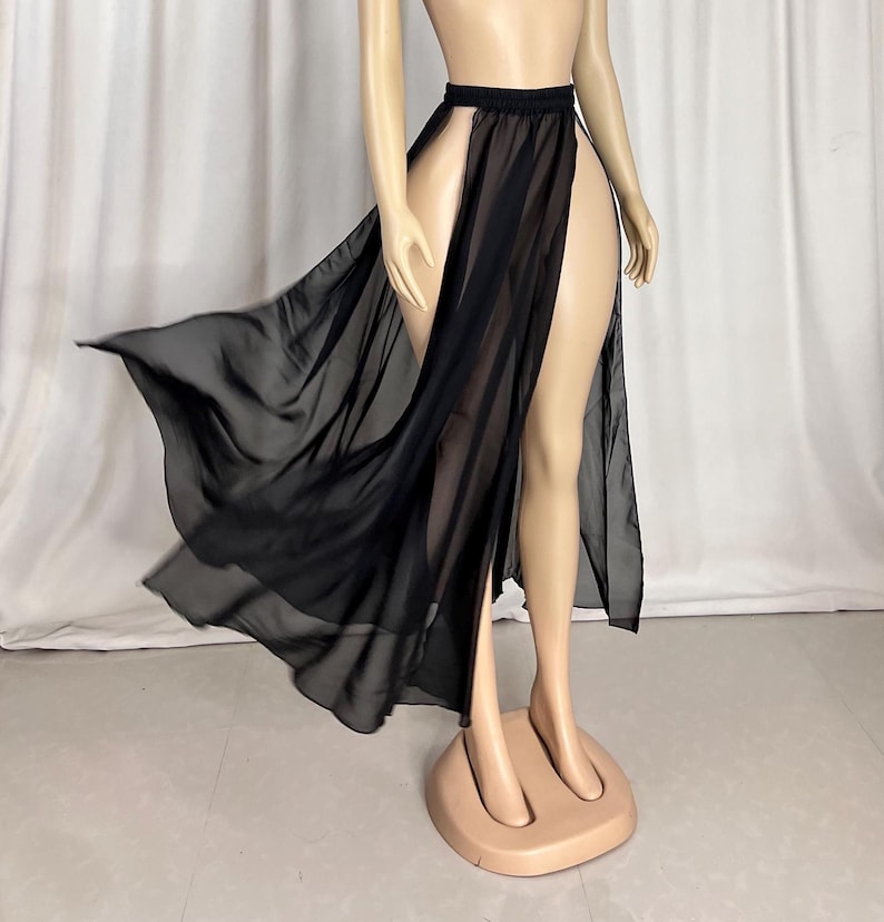 Puede incluir: Una falda maxi negra transparente con una abertura alta en la parte delantera. La falda est&aacute; hecha de una tela ligera y fluida y tiene un dise&ntilde;o simple y elegante.