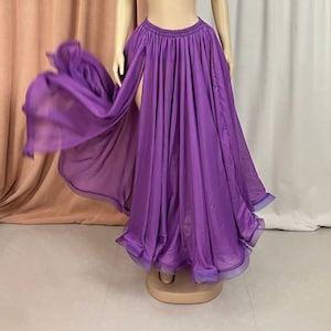 May include: A long purple chiffon skirt with a high slit and a gathered waistband. The skirt is flowing and has a ruffled hem.