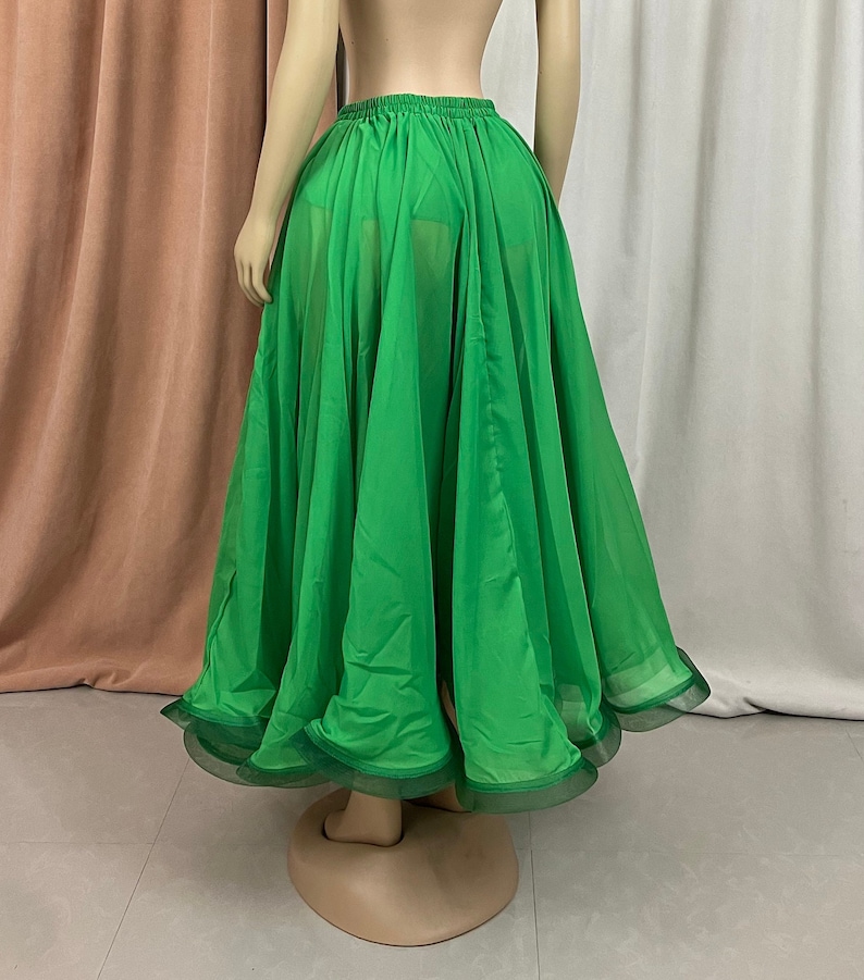 May include: A bright green, flowing chiffon skirt with a ruffled hem. The skirt is gathered at the waist and has a sheer, flowing fabric.