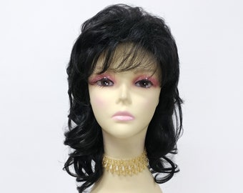 May include: A black wig with long, curly layers and a fringe. The wig is styled on a mannequin head with a gold beaded necklace.