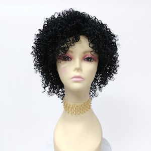 May include: A black curly wig on a mannequin head. The wig is styled in a short, afro-like style.