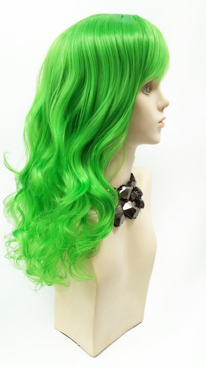 May include: A bright green wig with long, wavy hair. The wig is styled with a side part and bangs.