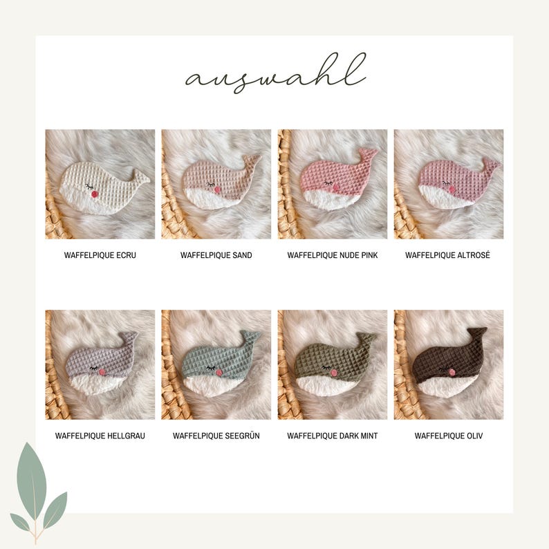 May include: A selection of eight crocheted whale-shaped baby toys in various colors, including ecru, sand, pink, and gray. Each whale has a white belly and is displayed on a textured surface.