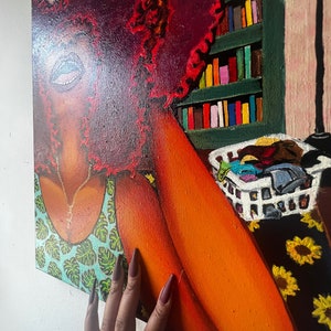 May include: A painting of a woman with a large, red afro. She is wearing a green and blue tank top with a floral pattern. The painting is set in a room with a bookshelf and a basket of clothes.