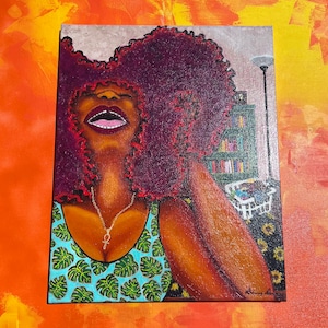 May include: A painting of a woman with large, curly, red hair wearing a blue tank top with a green tropical leaf pattern. She is wearing a silver necklace with an ankh pendant. The background is a blurry image of a bookshelf and a lamp.