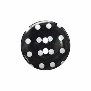 May include: Black button with white polka dots.