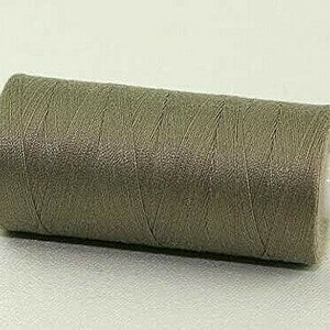 May include: A spool of Coats & Clark thread in a light brown colour. The spool is labelled "Coats" and "RBBY".