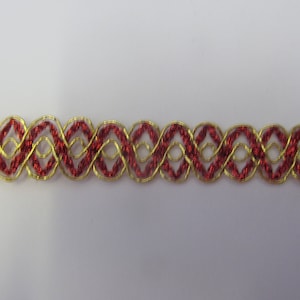 May include: Red and gold trim with an intricate woven design. This trim is perfect for adding a touch of elegance to any project.