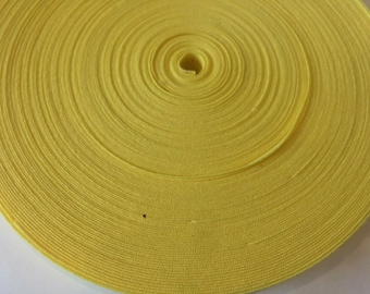 May include: A roll of bright yellow elastic ribbon, perfect for crafting and sewing projects.