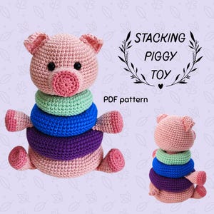 May include: A crocheted stacking toy shaped like a pig, featuring a pink body, head, and limbs. The pig has a pink snout and black eyes. The toy includes green, blue, and purple stacking rings. Text on the image reads "Stacking Piggy Toy" and "PDF pattern."