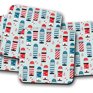 May include: Set of four blue and white coasters with a lighthouse and life preserver pattern on a light blue background.