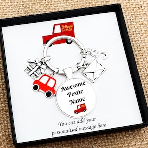May include: A silver keyring with postal-themed charms, including a red post van, a gift, and an envelope. The central charm reads "Awesome Postie Name" with a red post van graphic. The text "You can add your personalised message here" is also visible.