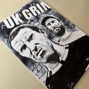 May include: Black and white artwork featuring two men's faces, with the text "UK GRIM" at the top. The artwork is signed "Chris Asbran 2023" in the bottom right corner. The style is reminiscent of a comic book.