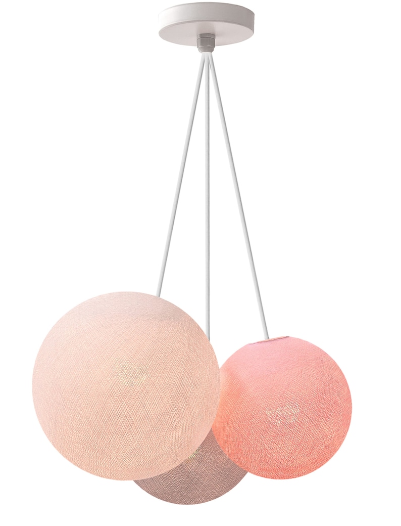 May include: A three-light pendant light fixture with three round fabric shades in pink, peach, and beige.