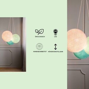 May include: Three round, hanging LED light fixtures made of cotton fabric. The lights are in shades of pink, green, and light blue. The lights are labeled as "LED H&auml;ngelampe", "&Ouml;kologisch", "Handmade", "LED", and "H&ouml;henverstellbar".