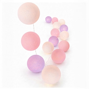 May include: A string of decorative spherical lights featuring a textured, woven surface. The spheres are arranged in a gradient of soft pastel colors, including shades of light pink, pale lavender, and cream, connected by a thin, translucent wire.