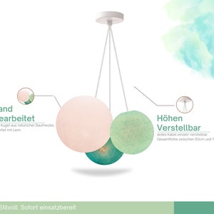 May include: A three-light pendant lamp with white cords and three round fabric shades. The shades are pink, green, and teal. The lamp is adjustable in height, with each cord adjustable from 50 to 180 cm. The lamp is handmade with natural cotton and glued together.