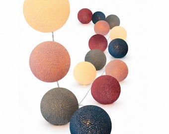 May include: A string of decorative spherical lights featuring a textured, woven thread finish. The globes come in a variety of colors including cream, dusty pink, dark red, navy blue, and slate gray, arranged along a thin, flexible white wire.