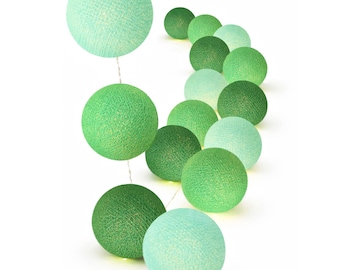 May include: A string of decorative spherical lights featuring a gradient of green shades, ranging from pale mint to deep forest green. Each orb is constructed from a textured, woven thread material that emits a soft, warm glow when illuminated.