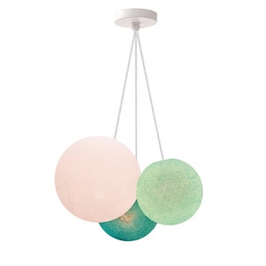 May include: A white ceiling light fixture with three hanging cotton ball shades. The shades are pink, green, and teal.