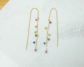 May include: A pair of gold chain earrings with a rainbow of small gemstone beads hanging from each chain.