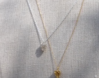 May include: Three silver, gold, and rose gold necklaces with small, textured heart-shaped pendants.