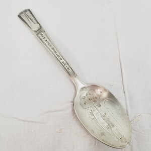 May include: Silver teaspoon with the inscription "24th St. 0. G. 202. NEW YORK" on the handle.