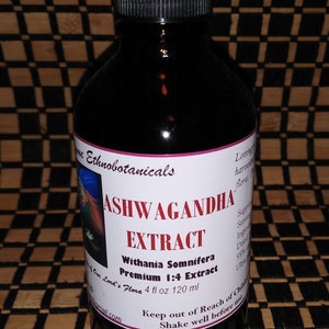 May include: A brown glass bottle with a dropper top, labelled "Ashwagandha Extract" with the text "Withania Somnifera Premium 1:4 Extract" and "Our Lord's Flora 4 fl oz 120 ml".