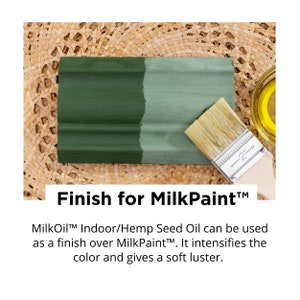 May include: A wooden plank painted with two shades of green paint, with a paintbrush resting on it. The text "Finish for MilkPaint" is displayed below the plank. A small container of oil is in the background.