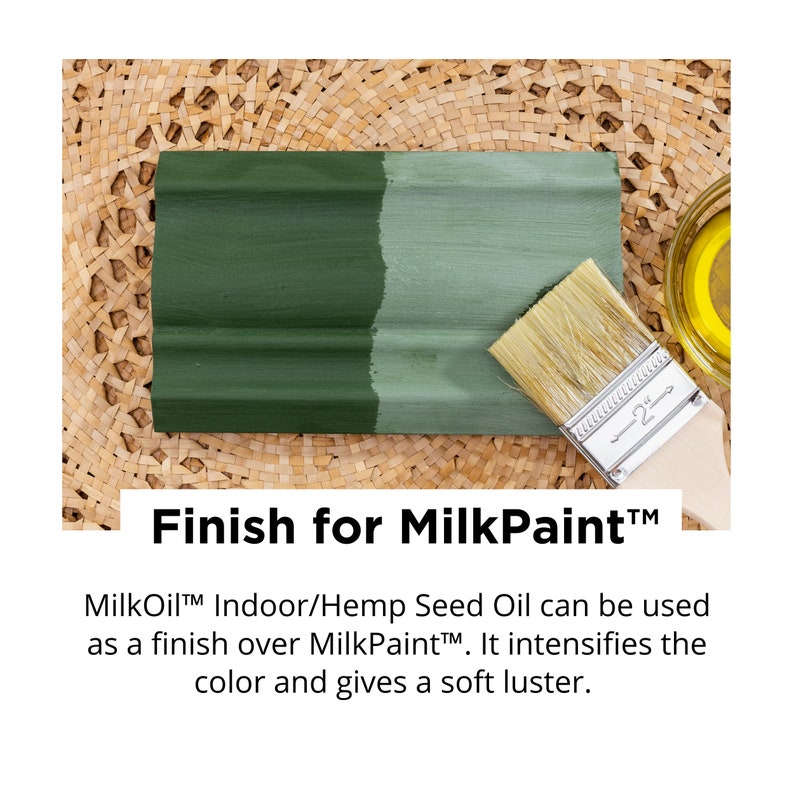 May include: A wooden plank painted with two shades of green paint, with a paintbrush resting on it. The text "Finish for MilkPaint" is displayed below the plank. A small container of oil is in the background.