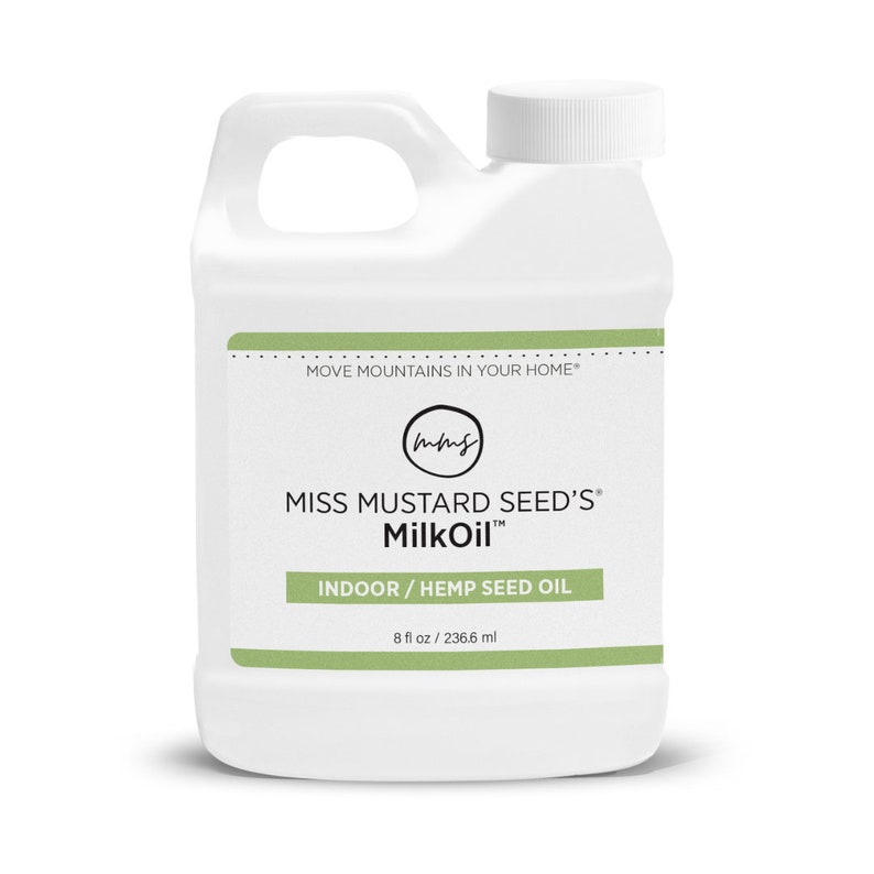 May include: White plastic bottle of Miss Mustard Seed's MilkOil. The label includes the text "MOVE MOUNTAINS IN YOUR HOME" and "INDOOR / HEMP SEED OIL". The bottle contains 8 fl oz / 236.6 ml of product.