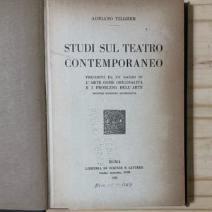 May include: An open book with a light tan cover. The title "STUDI SUL TEATRO CONTEMPORANEO" is printed in large, bold, black letters. The author's name, "ADRIANO TILGHER", is above the title. The text "Printed in Italy" is at the bottom.