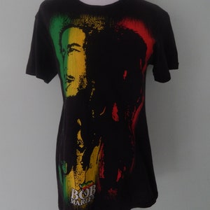 May include: Black t-shirt with a colorful image of Bob Marley and the text "Bob Marley" printed on the front.