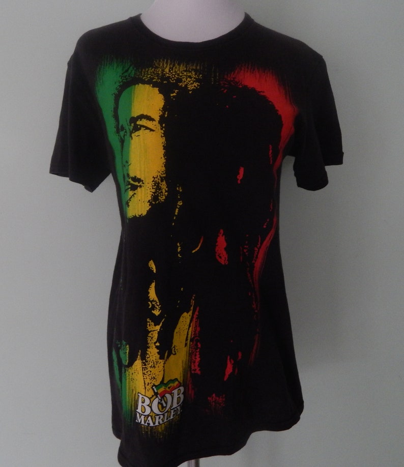 May include: Black t-shirt with a colorful image of Bob Marley and the text "Bob Marley" printed on the front.