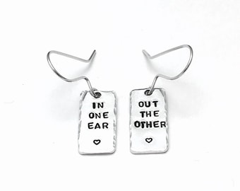 Hand stamped personalised aluminium drop earrings customised with 'In one ear, out the other', lightweight hypoallergenic jewelry, teen gift